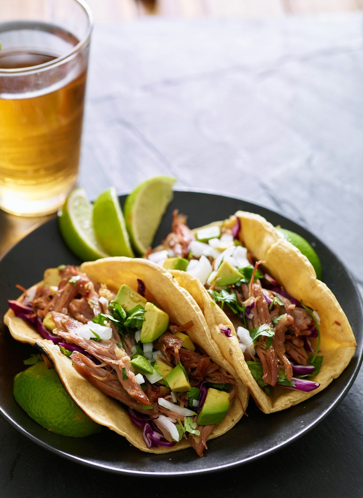 mexican street tacos with pork carnitas, red cabbage, cilantro and onion